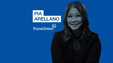 Professional woman smiling, wearing business attire on a blue background with TransUnion logo and name.