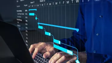 Person typing on laptop with a project management chart overlay